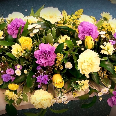 lemon yellow and lilac casket spray