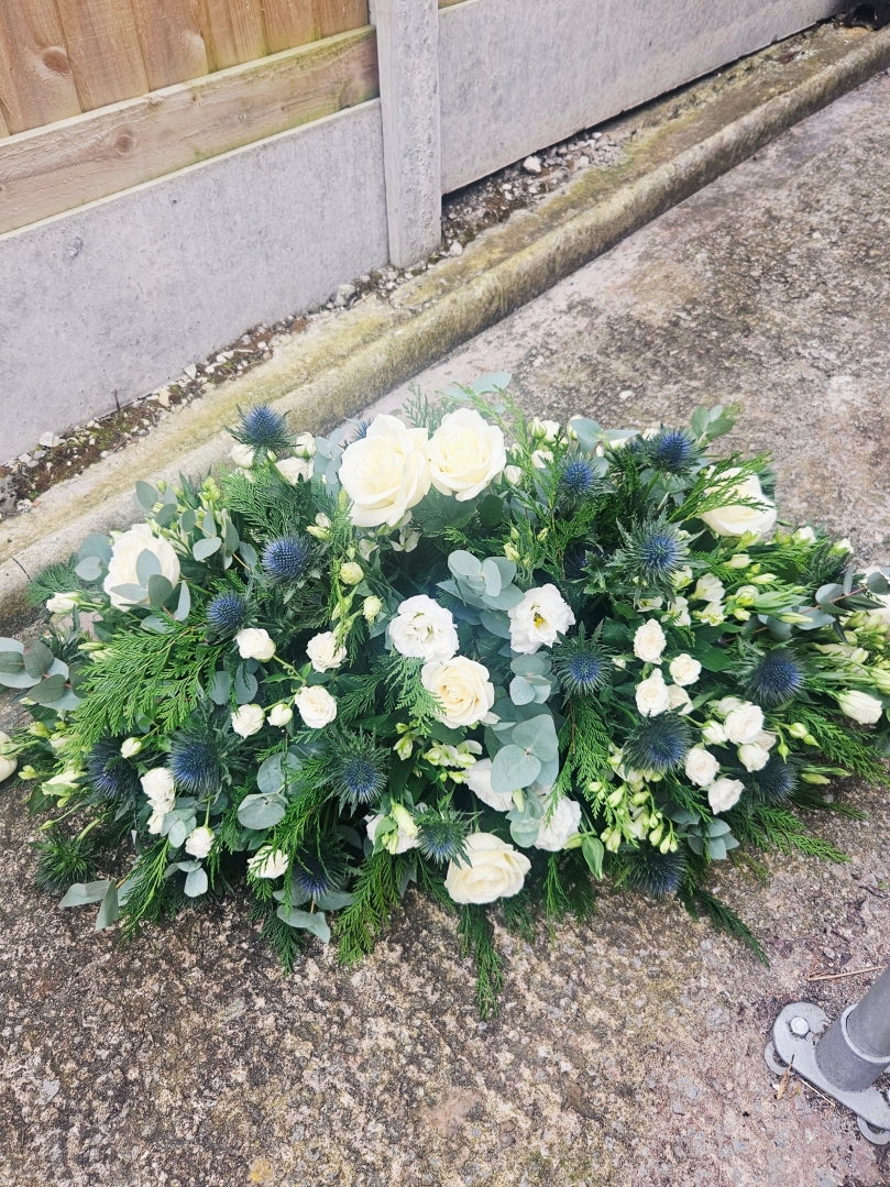 Blue and white casket spray